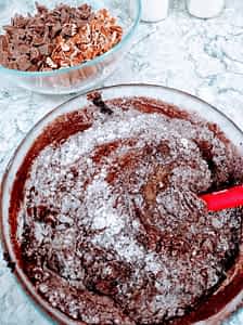 masa de brownies en tazón con harina mezclando