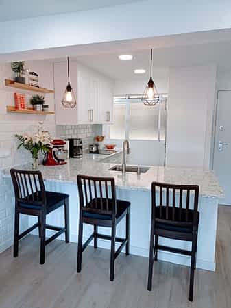 La encimera "peninsula" con sillas. vista a la cocina desde la encimera peninsula