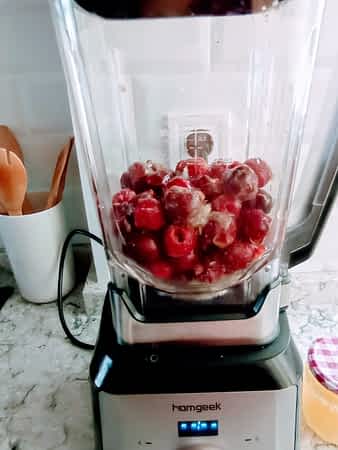 las cerezas congeladas están en la jarra de la licuadora