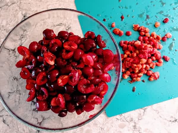 Deshuesa las cerezas/picotas. las cerezas deshuesadas en un tazón