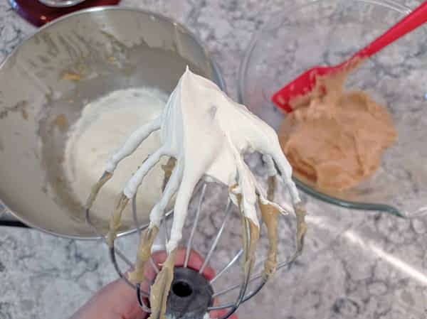 una batidora de varillas con la nata montada a picos rígidos