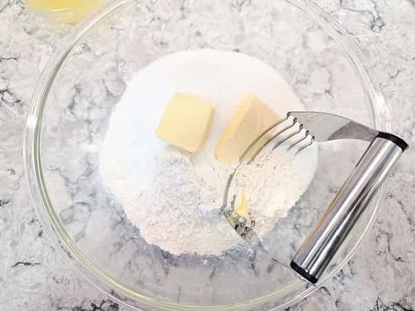 un bol grande con los ingredientes secos y la mantequilla en trozos